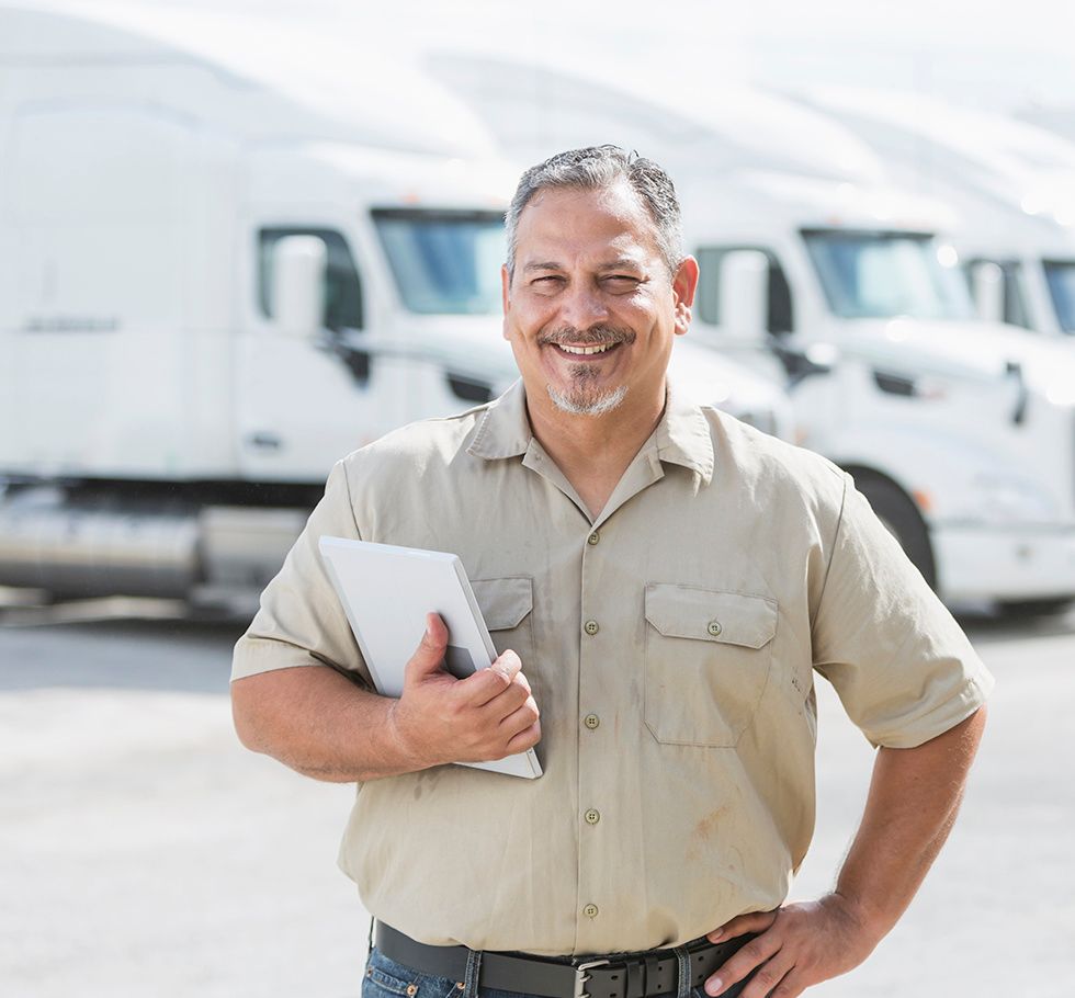 Man standing in front of semi-trucks